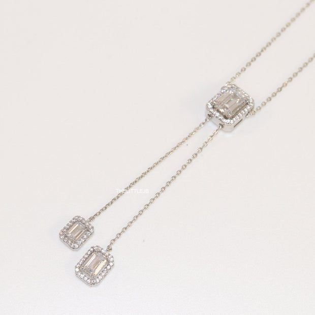 Emerald cut cubic zirconia stones in different sized on sleek platinum plated chain
