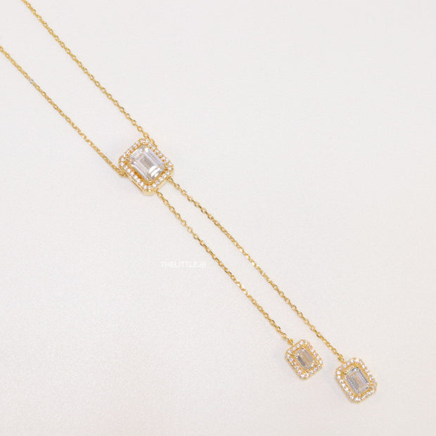 Emerald cut cubic zirconia stones in different sized on sleek gold plated chain