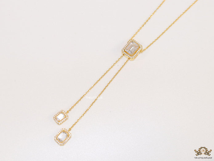 Emerald cut cubic zirconia stones in different sized on sleek gold plated chain