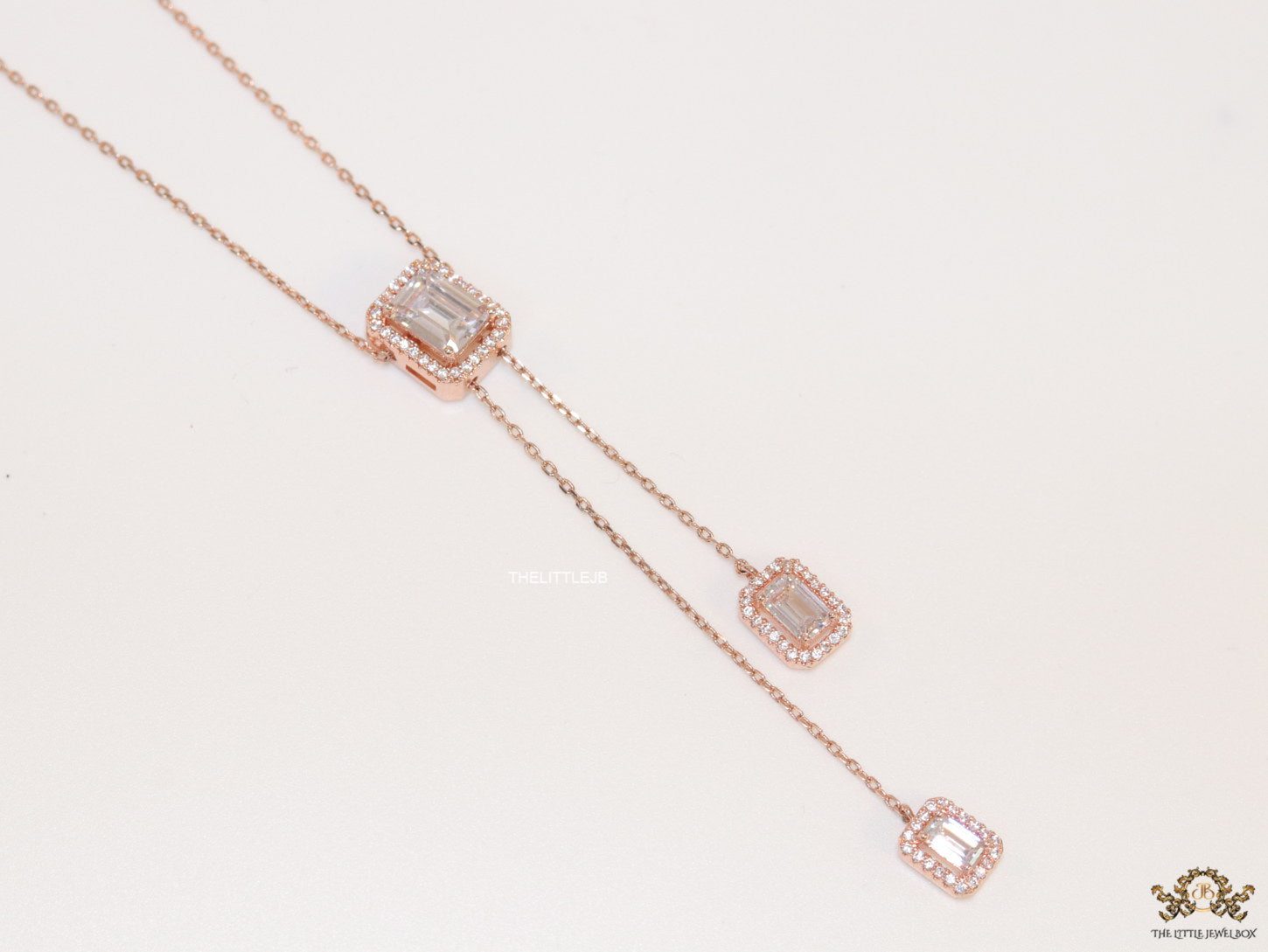 Emerald cut cubic zirconia stones in different sized on sleek rose gold plated chain