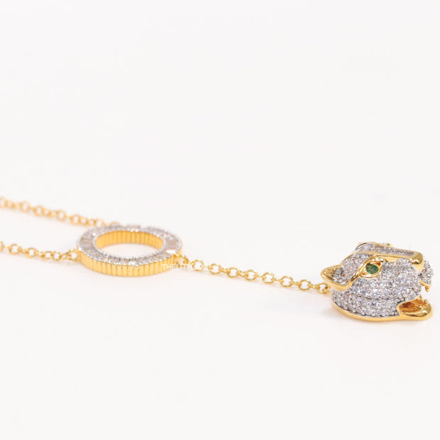 Gold plated sleek chain with circular cubic zirconia disk and gold plated panther face motif pendant