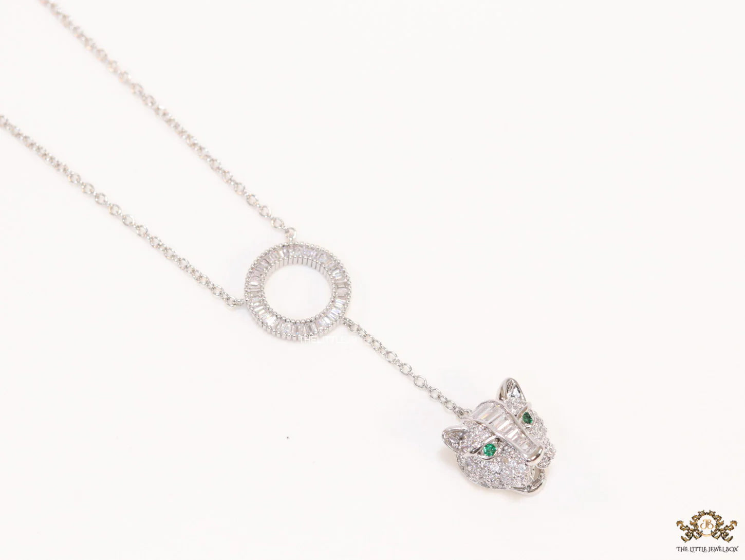Platinum plated sleek chain with circular cubic zirconia disk and Platinum plated panther face motif pendant