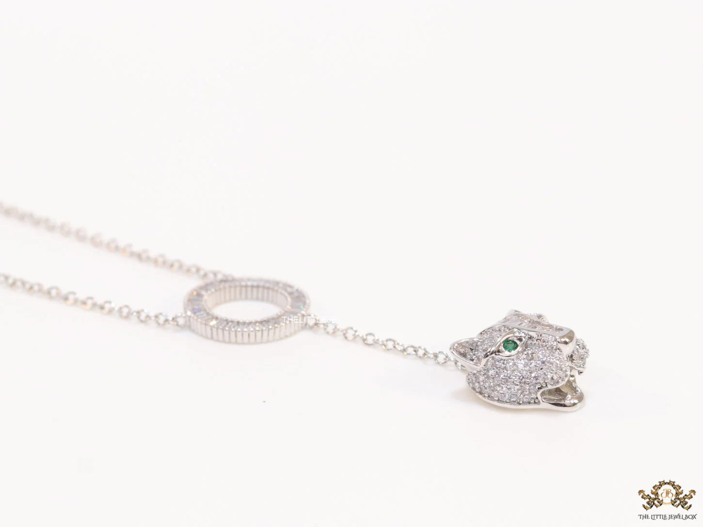 Platinum plated sleek chain with circular cubic zirconia disk and Platinum plated panther face motif pendant