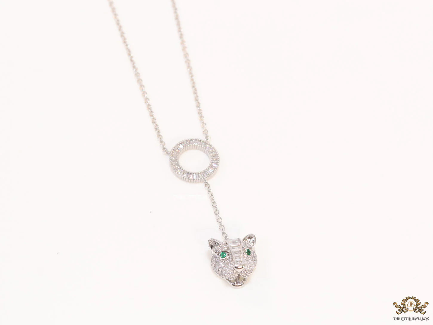 Platinum plated sleek chain with circular cubic zirconia disk and Platinum plated panther face motif pendant