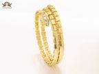 Gold triple layered serpentine bracelet with cz