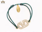 Alphabet V gold cz on green thread