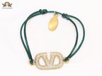 Alphabet V gold cz on green thread