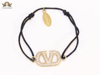 Alphabet V gold cz on black thread Bracelet