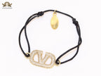 Alphabet V gold cz on black thread Bracelet