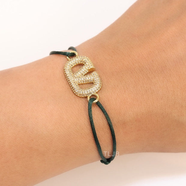 Alphabet V gold cz on green thread