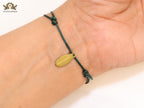 Alphabet V gold cz on green thread