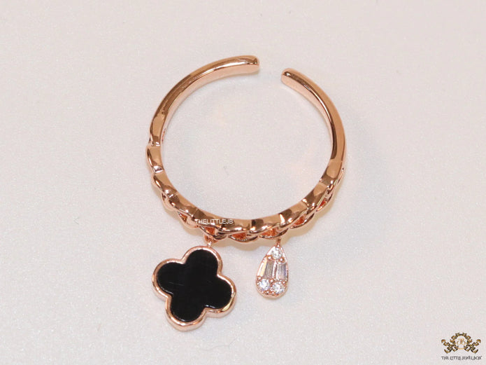 Rose gold plated link chain ring with black clover and cz drop