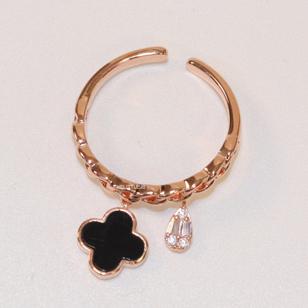 Rose gold plated link chain ring with black clover and cz drop
