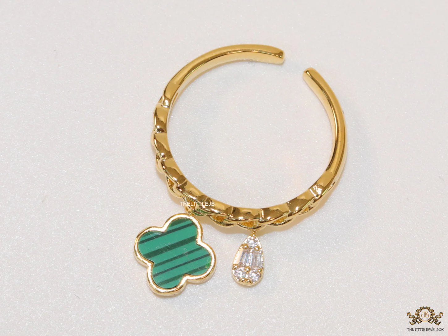 Gold plated link chain ring with malachite green clover and cz drop