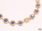 Gold plated link chain with blue cubic zirconia stones and gold plated Medusa motif charm.