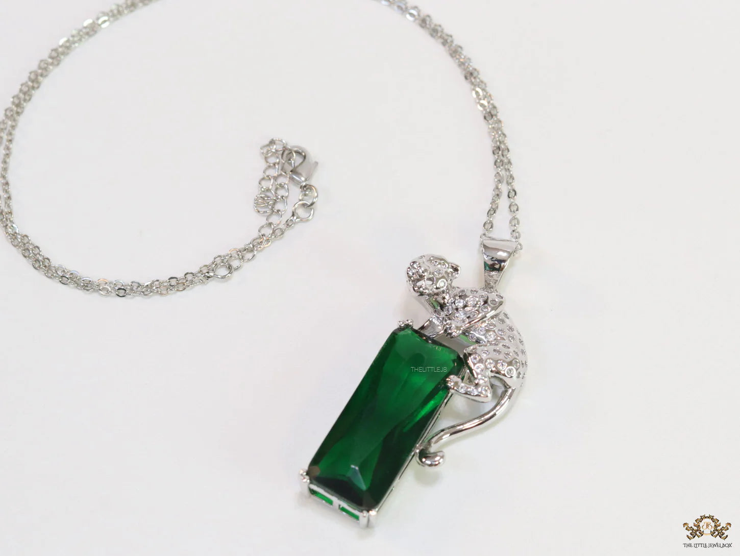 Platinum plated leopard on green stone pendant necklace with cz