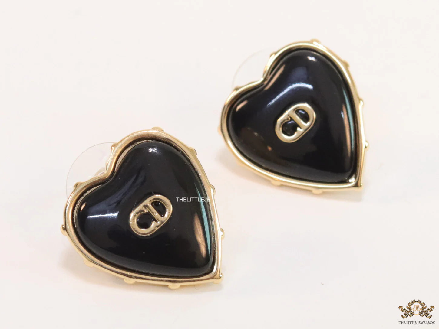 Heart shape black stud earrings with golden alphabets