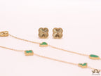 Emerald green clover heart and other shape charms on a sleek long gold plated chain with matching studs