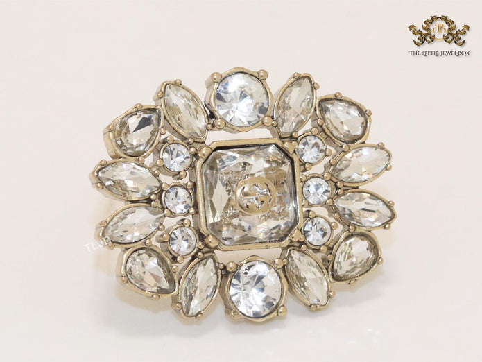 Double G brooch with uncut stones