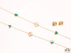 Emerald green clover heart and other shape charms on a sleek long gold plated chain with matching studs