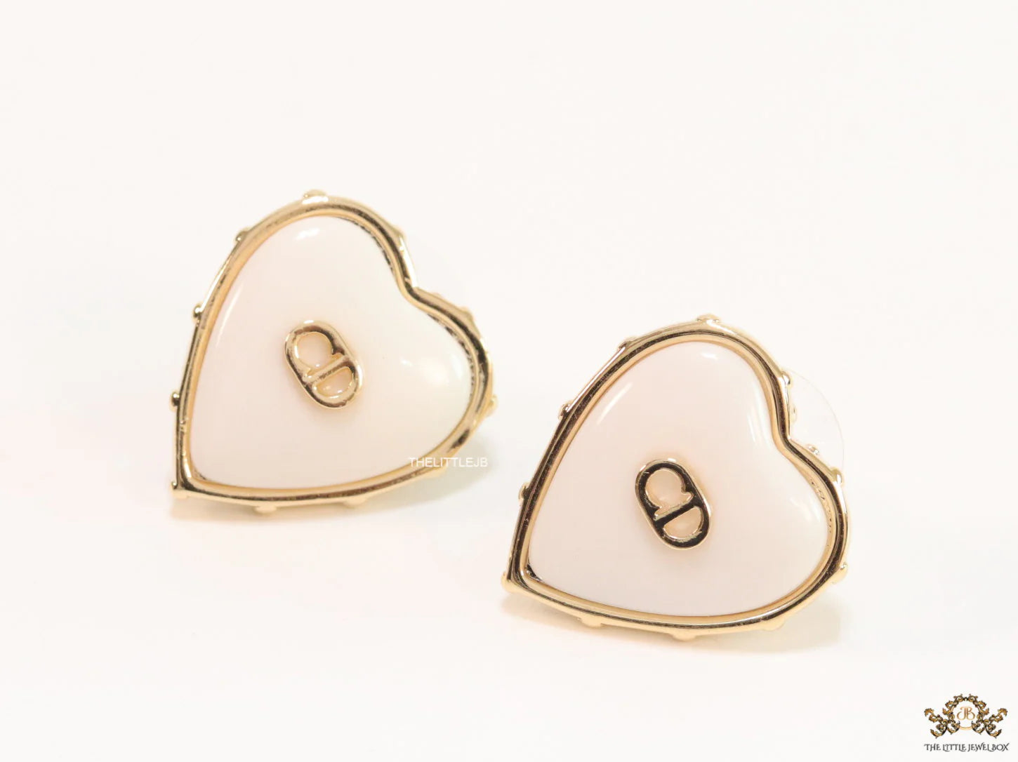 Heart shape white stud earrings with golden alphabets