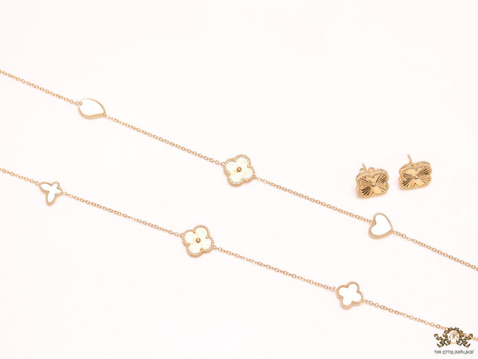Pearl white clover heart and other shape charms on a sleek long gold plated chain with matching studs
