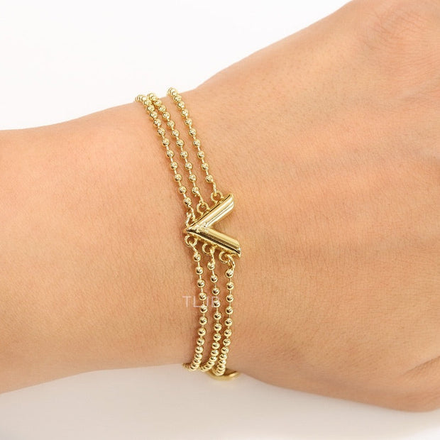 Alphabet V triple layered gold bracelet
