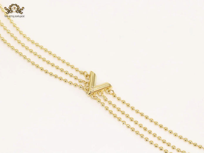Alphabet V triple layered gold bracelet