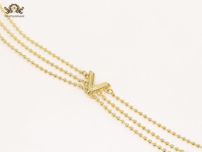 Alphabet V triple layered gold bracelet