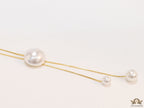 Sleek gold plated chain with different sized shell pearls.