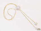 Sleek gold plated chain with different sized shell pearls.