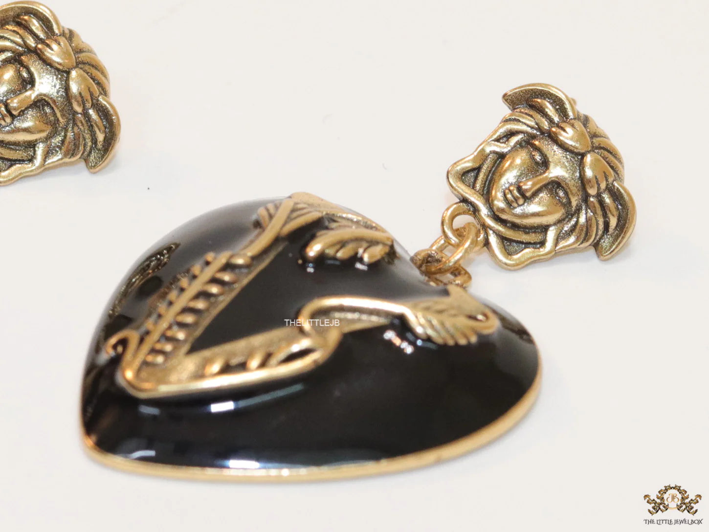 Gold plated medusa earrings with V motif black heart shape drop