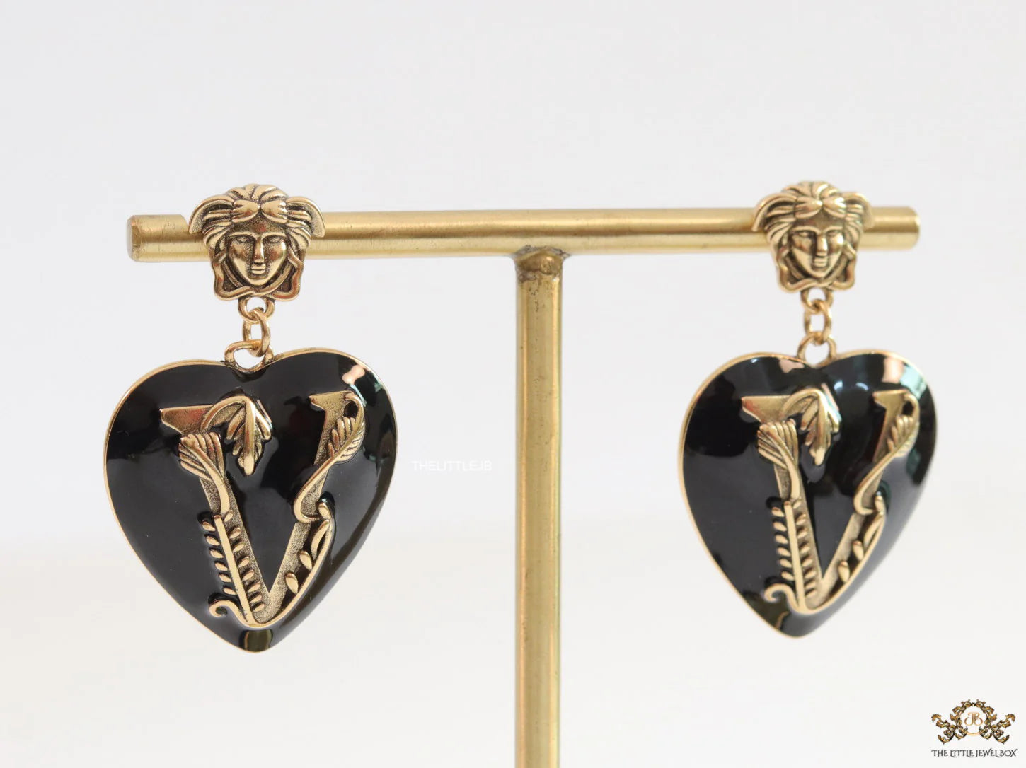 Gold plated medusa earrings with V motif black heart shape drop