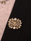 Double G brooch with uncut stones