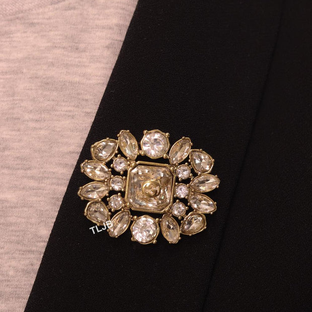 Double G brooch with uncut stones