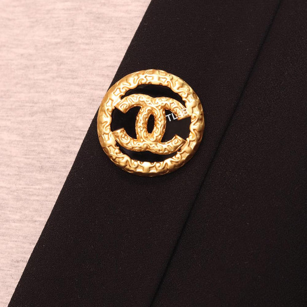 Double C gold foil and black enamel brooch