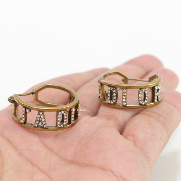 Broad golden hoops with cz alphabets