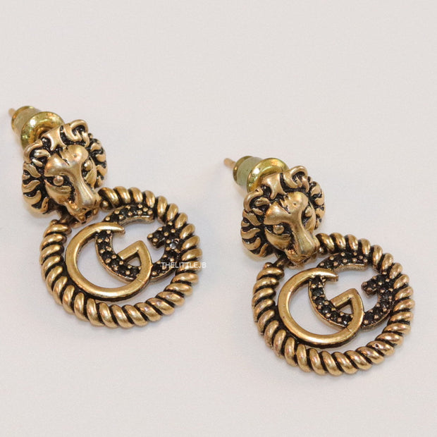 Lion head twin G earrings in gold finish