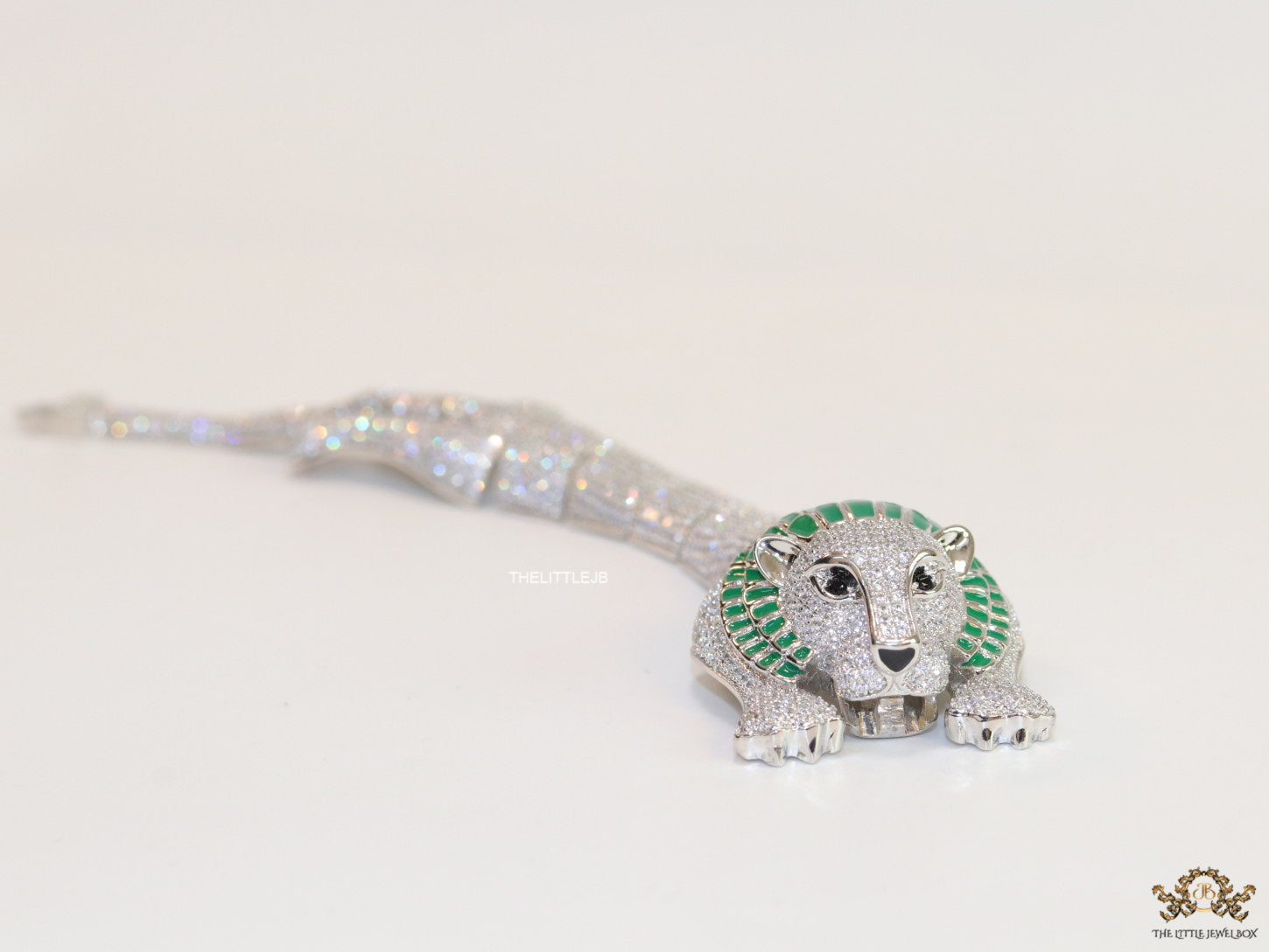 Platinum plated unique panther bracelet with cz and emerald green stones