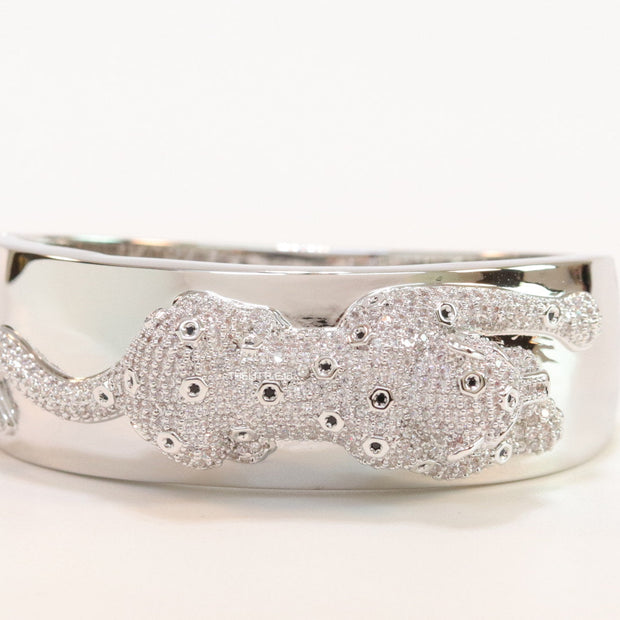 Broad band platinum bracelet with cz panther motif