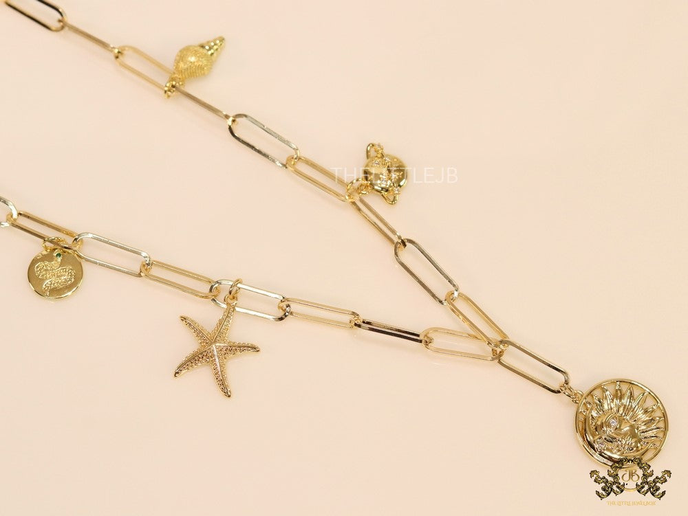 Gold plated link chain necklace with charms- snake, star fish, saturn, snail shell, Sun n Moon