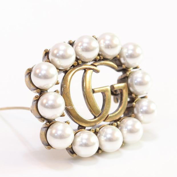 Pearls embraced alphabet brooch in gold finish