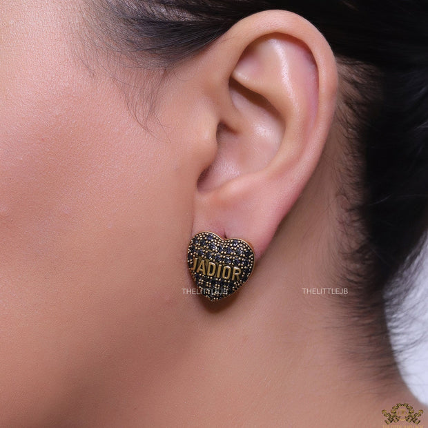 Heart shaped alphabet stud earrings in golden and black finish