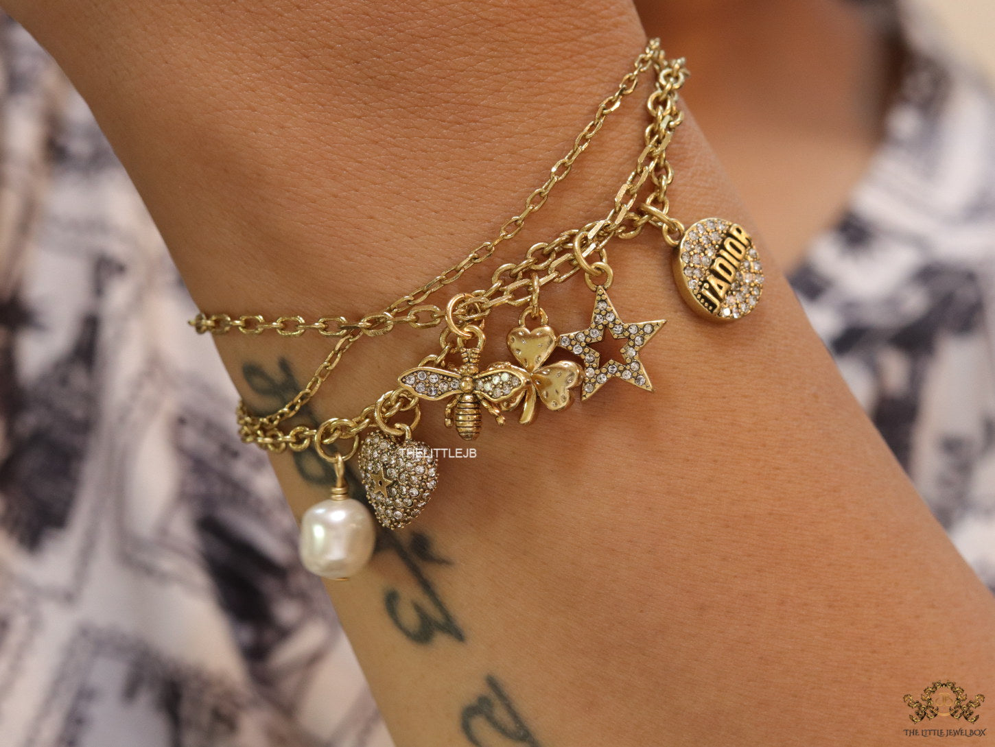 Multilayered gold plated chain bracelet with various cz charms