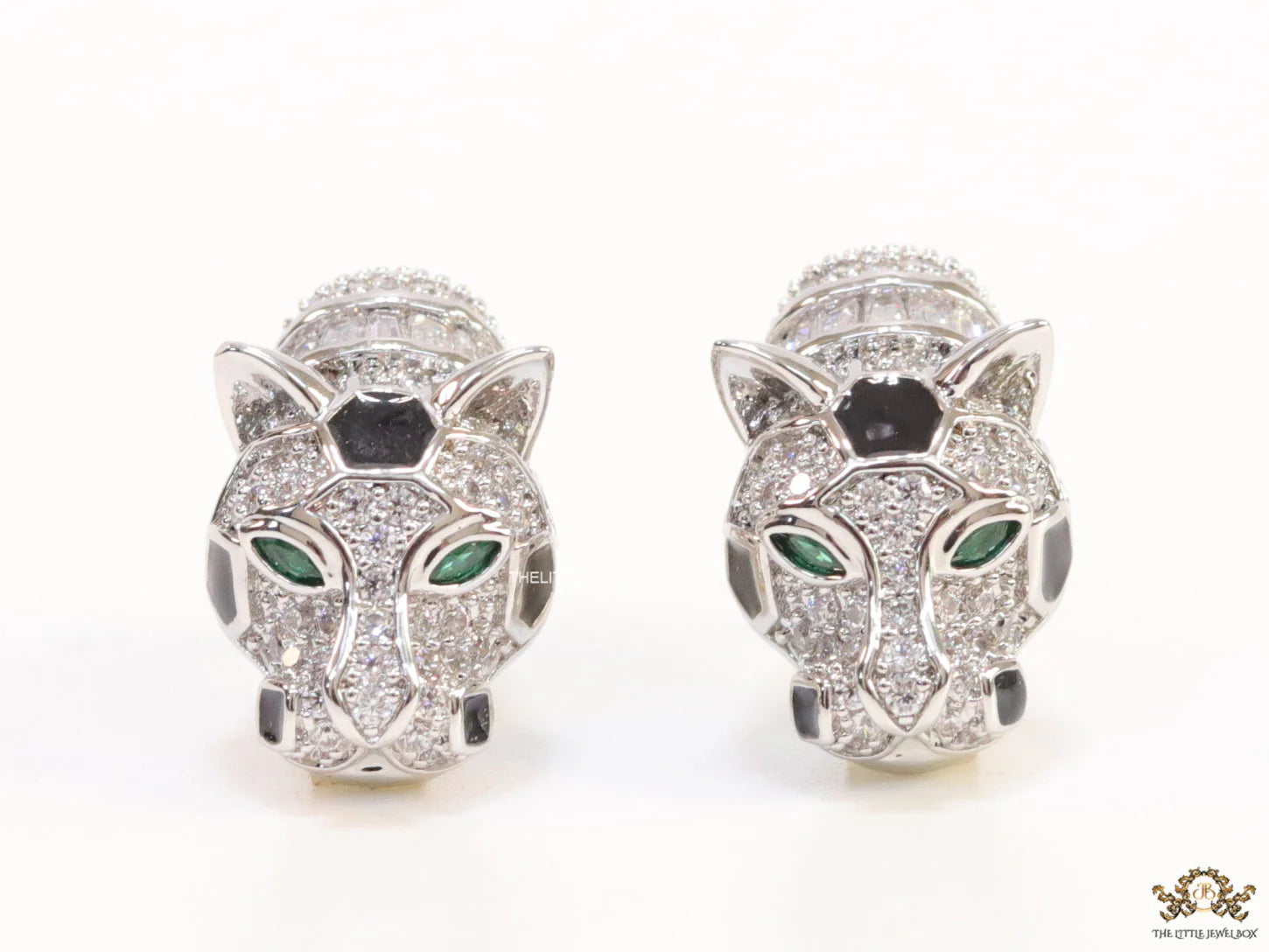Asymmetrical cz and baguette panther studs in platinum finish