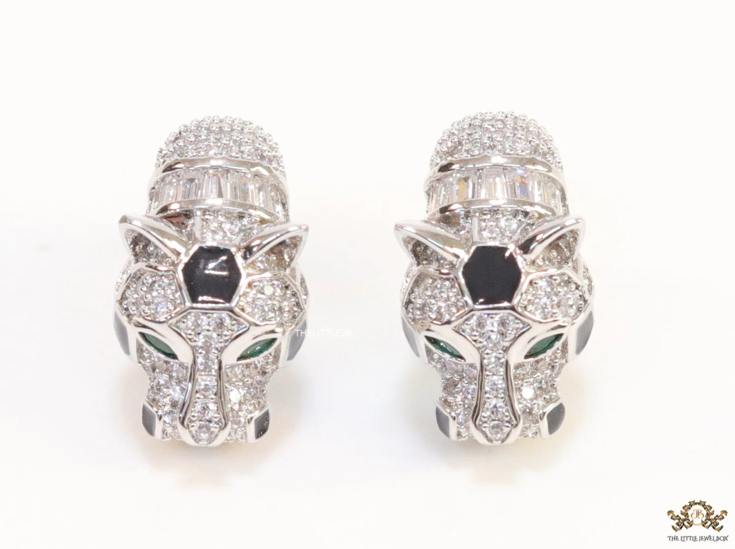 Asymmetrical cz and baguette panther studs in platinum finish