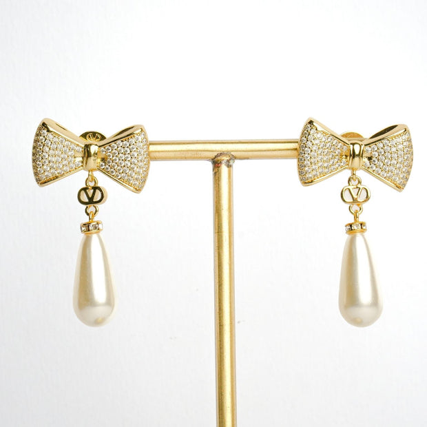 Alphabet V Bow Motif Long Pearl Dangler with CZ in Gold | Elegant Drop Earrings