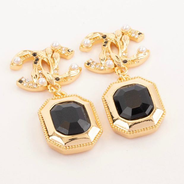 Gold Double C earrings with black enamel hanging