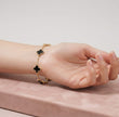 Gold plated chain bracelet with black clover