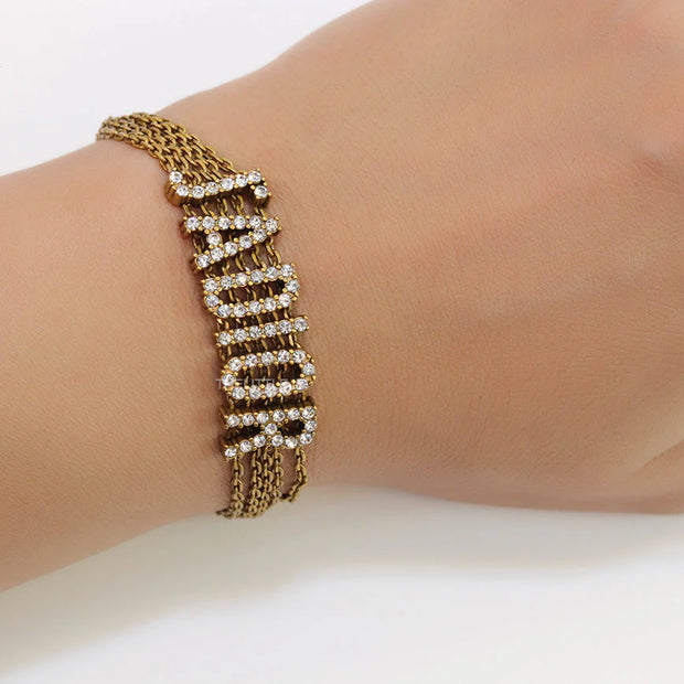 Multichain bracelet with cz alphabet CD in antique gold finish